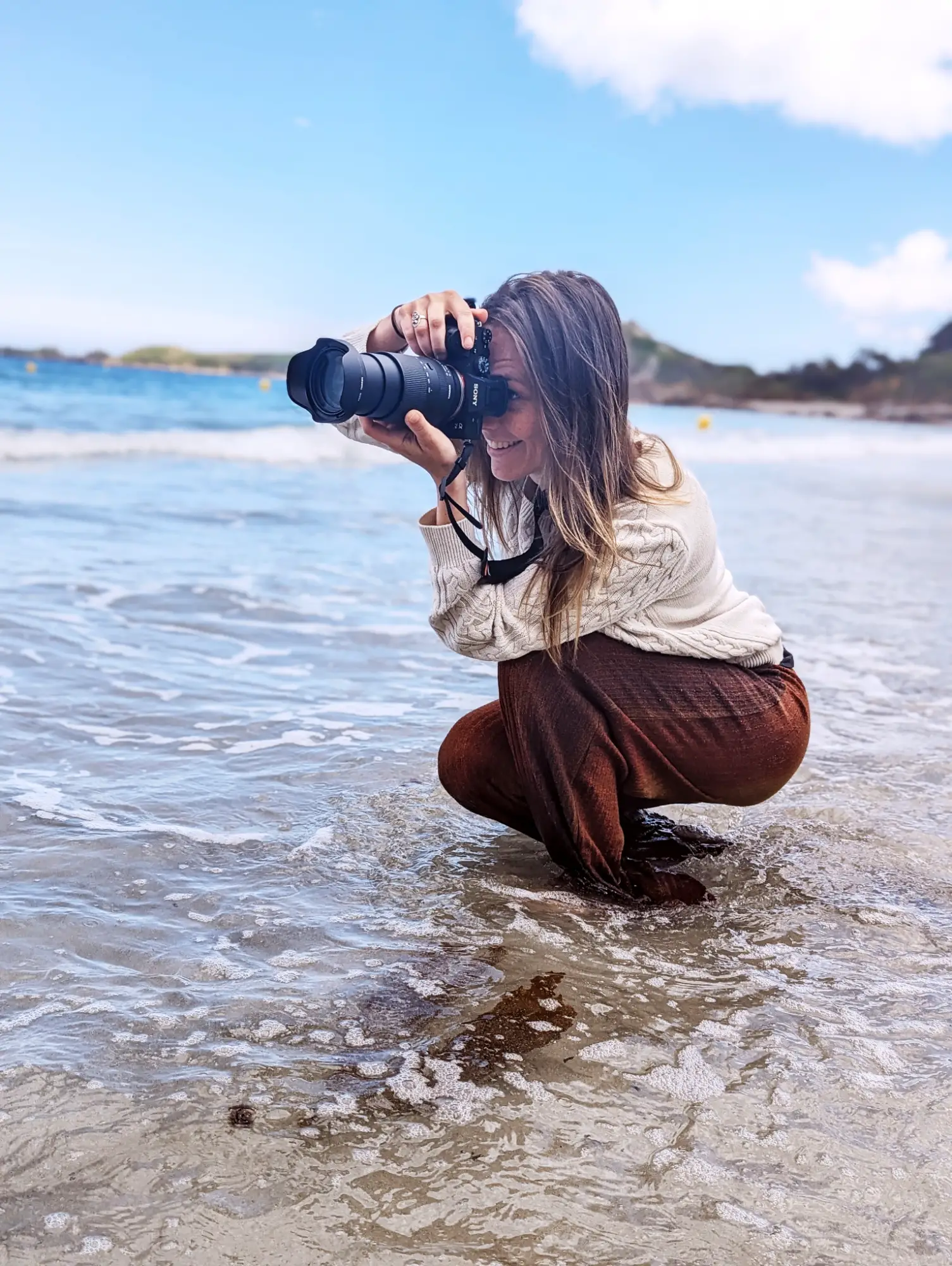 femme prenant un photo à la plage